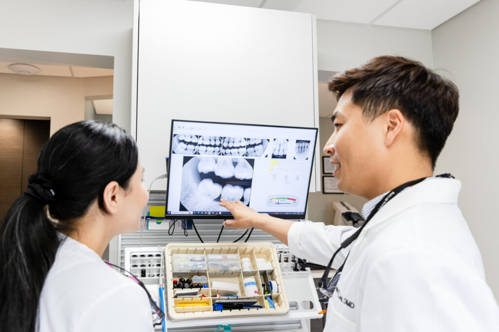 Dentist talking about dental implants to his patient.