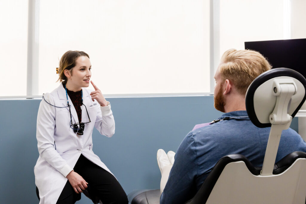 Our dentist with a patient during his consultation for a routine dental exam and cleaning.