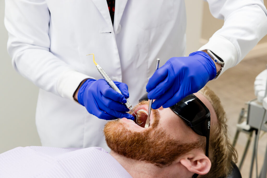 Our dentist with a patient during his dental sealant and fluoride treatment in Gainesville, VA.