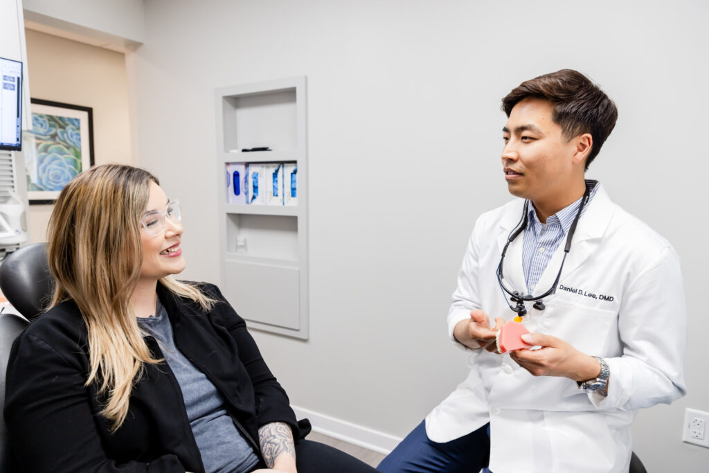 Cosmetic dentist talking to a patient about dental veneers in Herndon, VA.